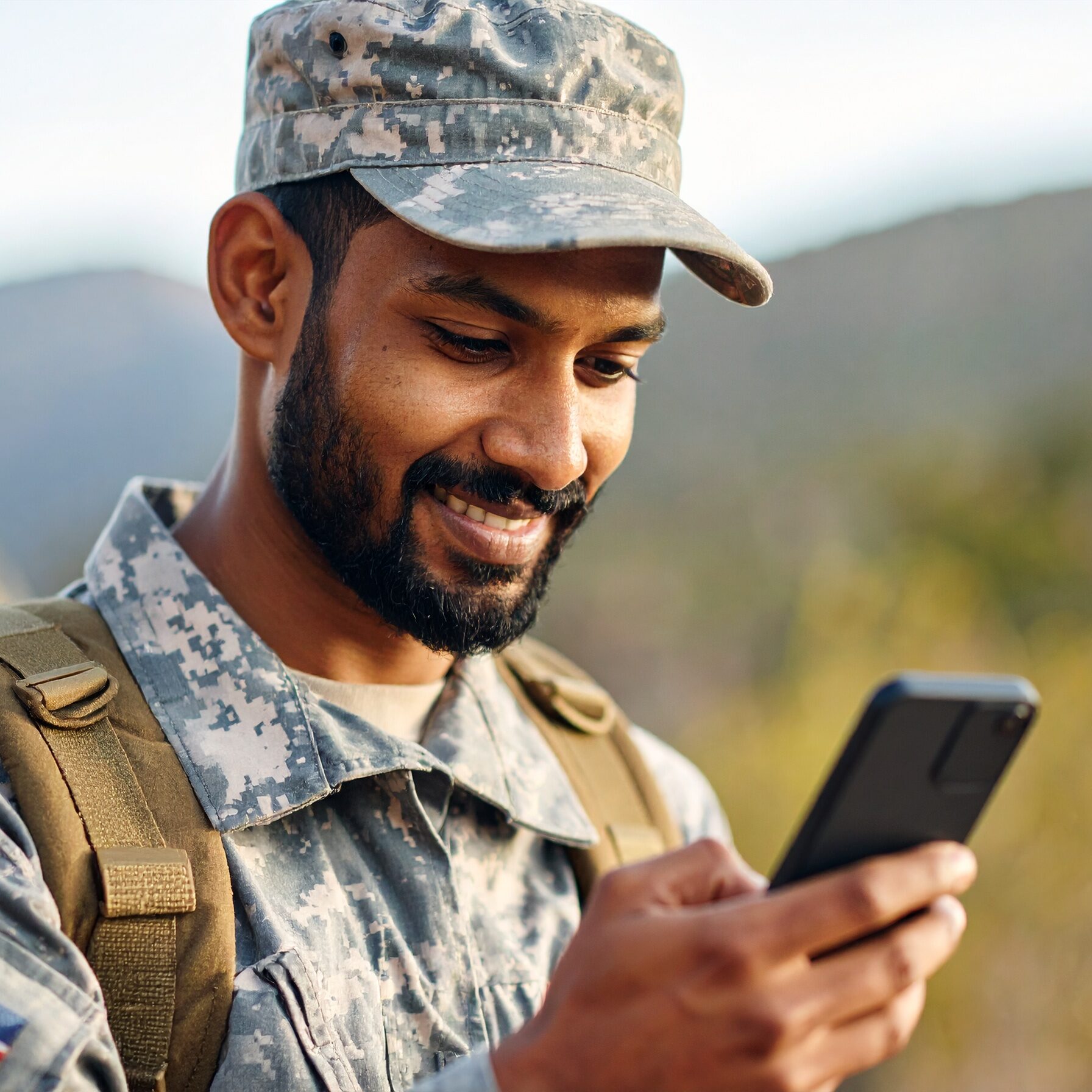 military reading an email on his phone military reading an email on his phone
